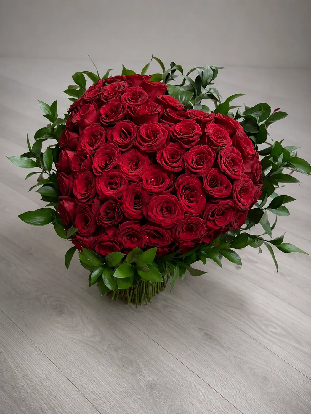 85 red roses arranged in a heart